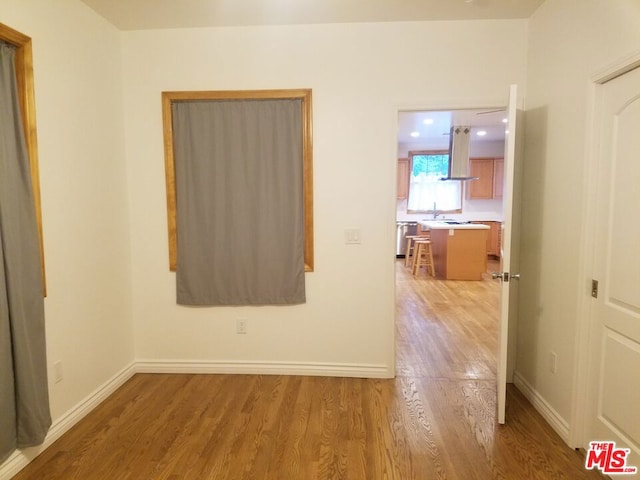 spare room with hardwood / wood-style floors