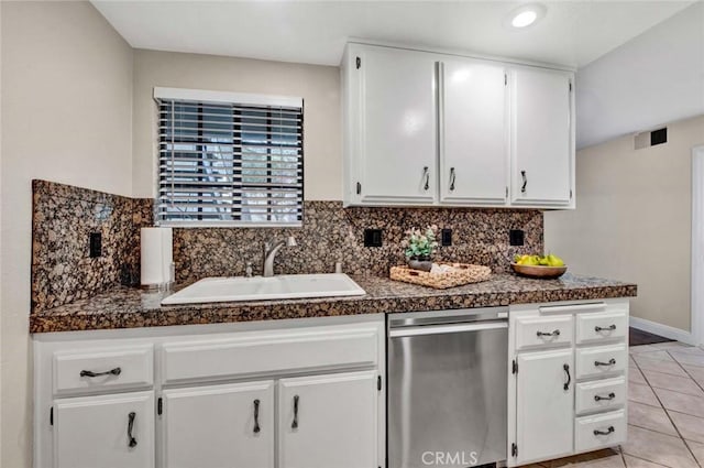 kitchen with sink, white cabinetry, dishwasher, light tile patterned floors, and backsplash