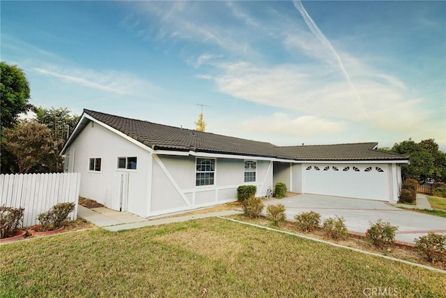 ranch-style home featuring a front lawn and a garage