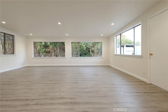 unfurnished room with light wood-type flooring