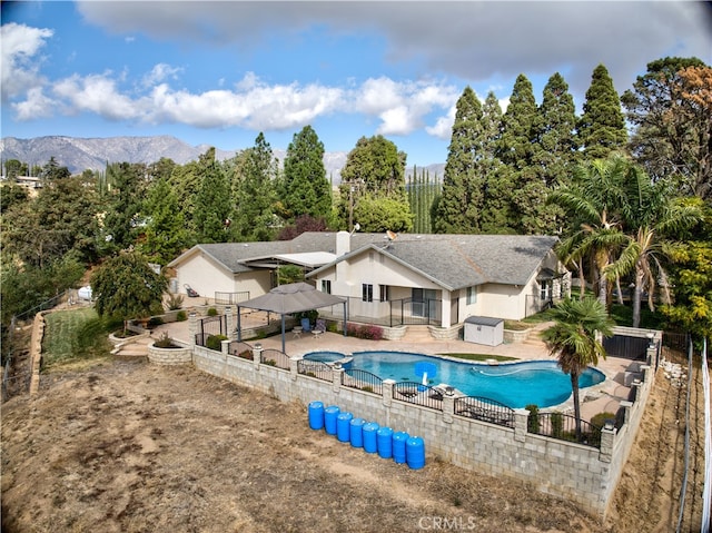 view of swimming pool with a mountain view and a patio area