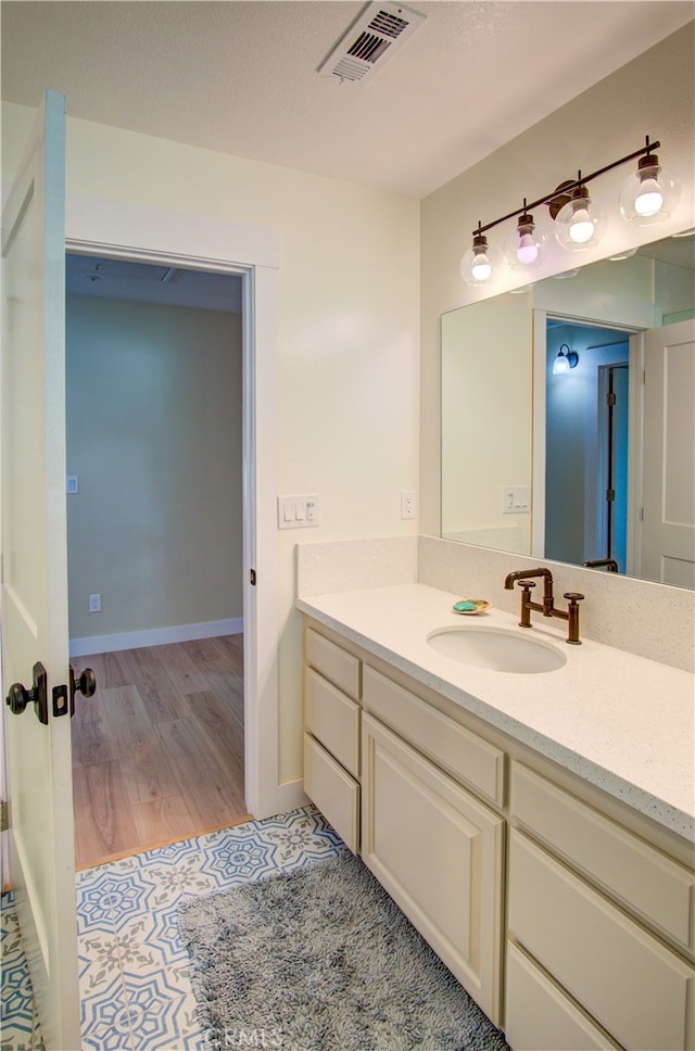 bathroom with vanity and hardwood / wood-style floors