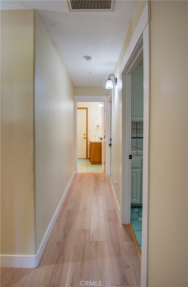 corridor featuring light hardwood / wood-style floors