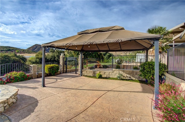 view of patio featuring a gazebo and a mountain view