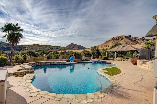 view of pool with a gazebo, a mountain view, and a patio area