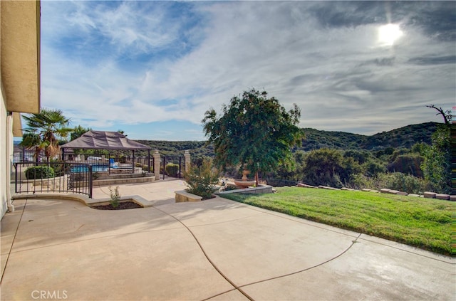 view of patio / terrace with a mountain view and a swimming pool