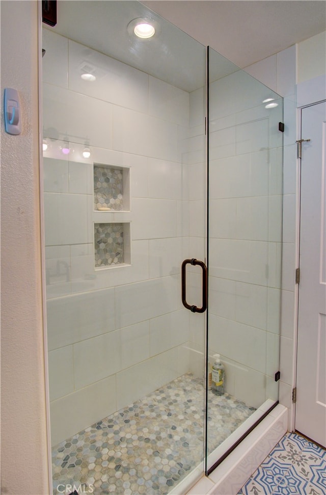 bathroom featuring a shower with door