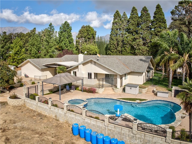 view of swimming pool featuring a patio, a gazebo, and an in ground hot tub