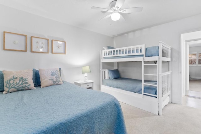 bedroom with ceiling fan and light carpet