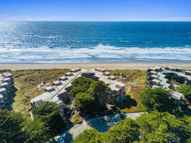 aerial view with a water view and a beach view