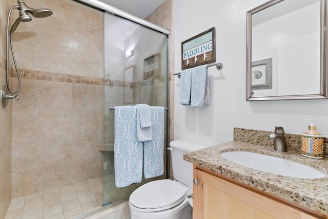 bathroom with toilet, vanity, and walk in shower