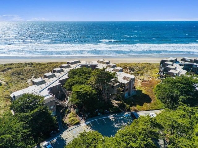 drone / aerial view featuring a view of the beach and a water view