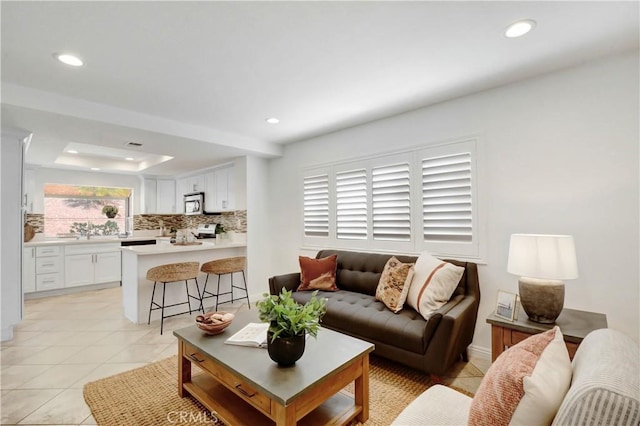 tiled living room with a tray ceiling