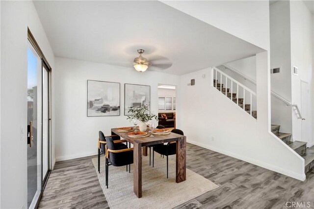 dining room with hardwood / wood-style flooring and ceiling fan