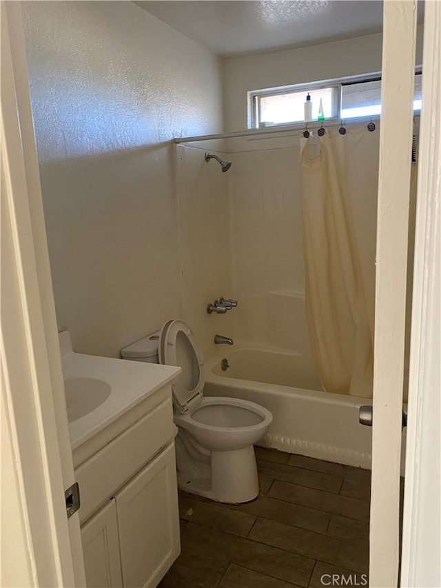 full bathroom featuring vanity, hardwood / wood-style flooring, toilet, and shower / bathtub combination with curtain