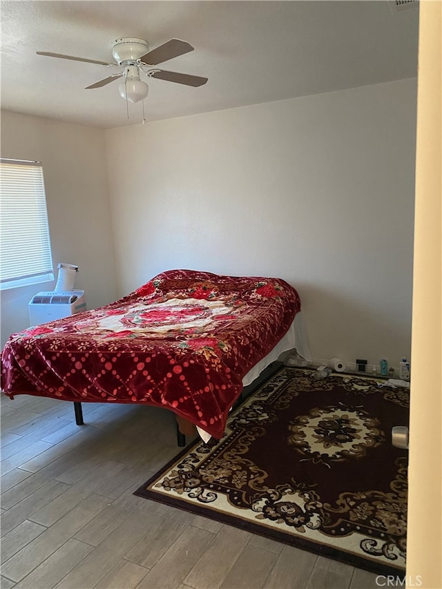 bedroom with light wood-type flooring and ceiling fan