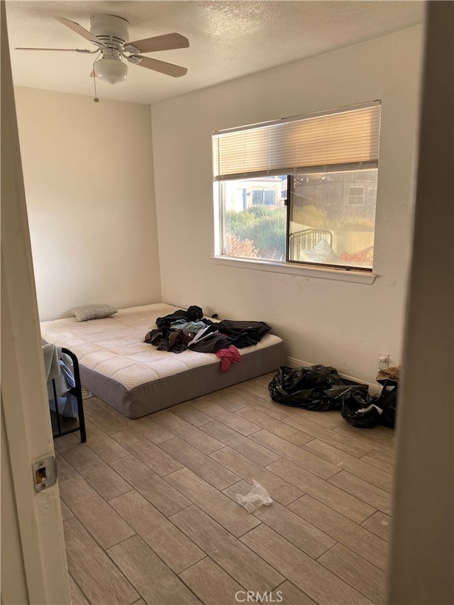 bedroom featuring light wood-type flooring and ceiling fan