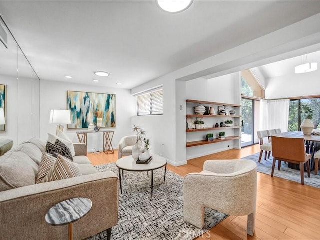 living area with recessed lighting and light wood-style floors
