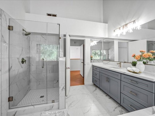 bathroom with visible vents, a marble finish shower, marble finish floor, and vanity