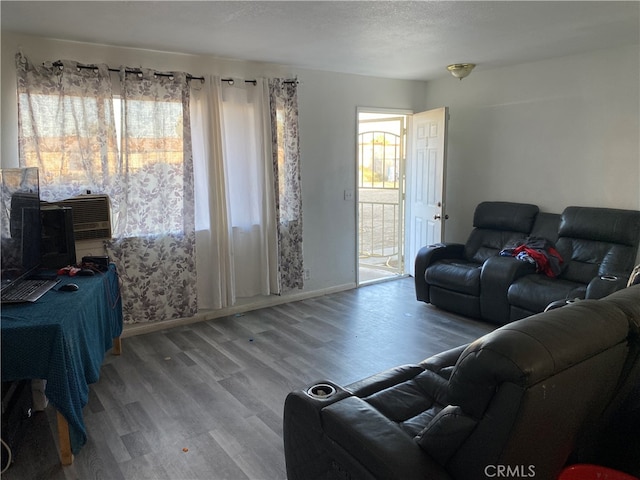 living room featuring a textured ceiling, hardwood / wood-style flooring, and a wealth of natural light