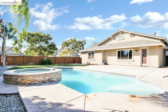 view of pool with an in ground hot tub and a patio