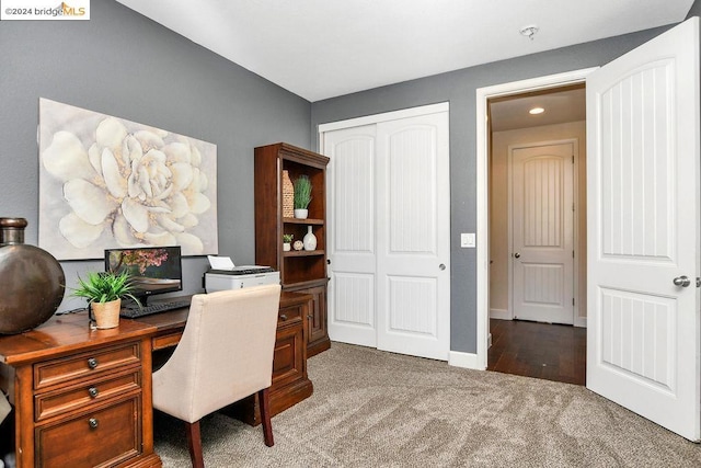 home office featuring dark colored carpet