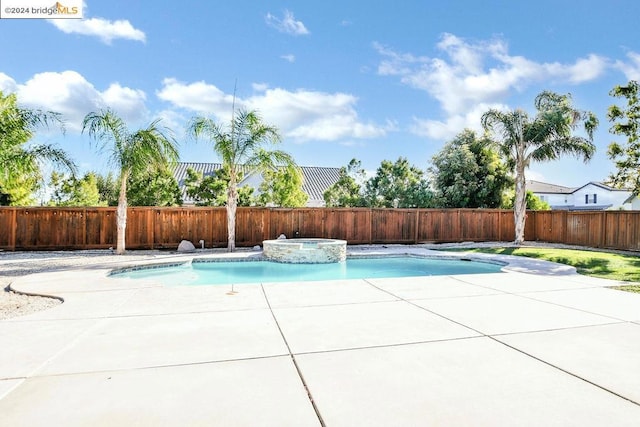 view of swimming pool featuring a patio and an in ground hot tub