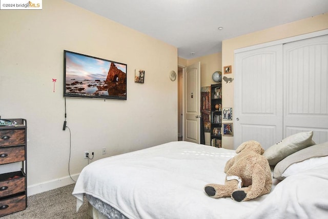 bedroom with a closet and light colored carpet