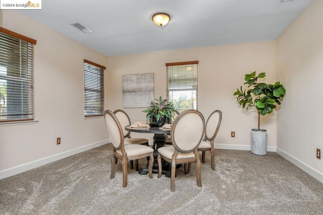 dining space featuring carpet floors and a healthy amount of sunlight