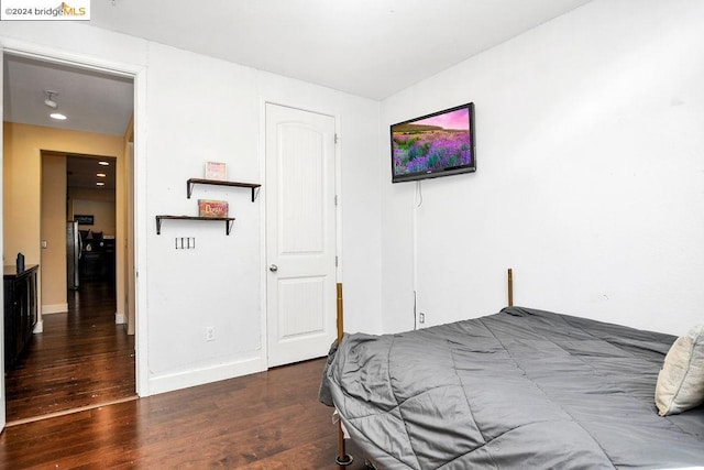 bedroom with dark wood-type flooring