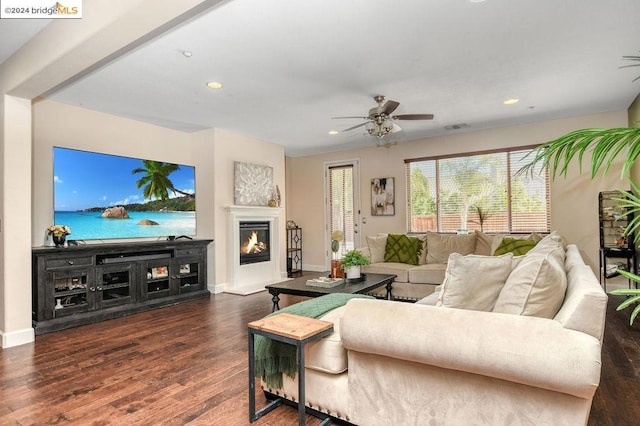 living room featuring ceiling fan and dark hardwood / wood-style flooring