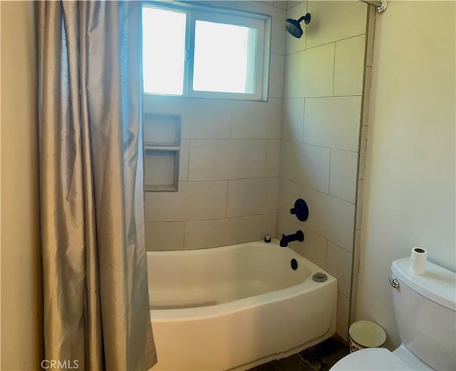 bathroom with toilet and shower / bath combo