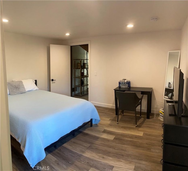 bedroom with dark wood-type flooring