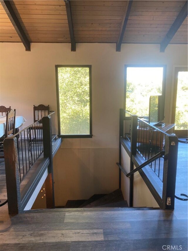 staircase with hardwood / wood-style floors, wood ceiling, and lofted ceiling with beams