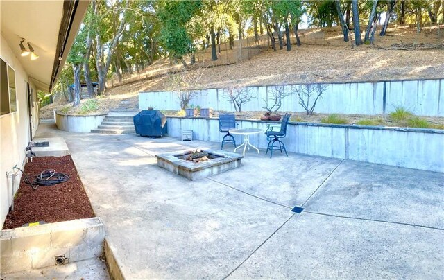 view of patio / terrace with a grill and an outdoor fire pit