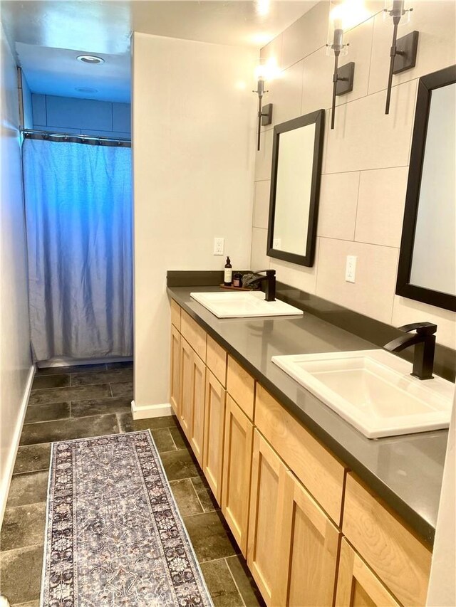 bathroom featuring vanity and a shower with shower curtain