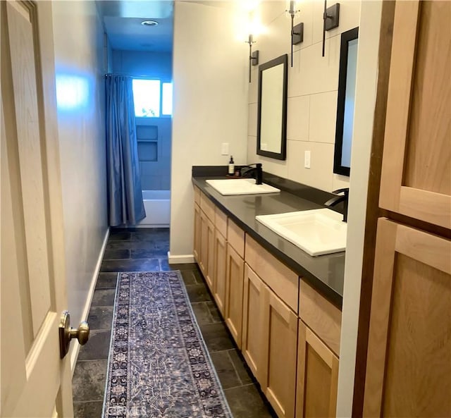 bathroom featuring vanity and shower / bath combo with shower curtain