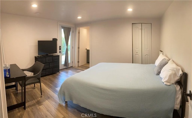 bedroom featuring light hardwood / wood-style floors and a closet