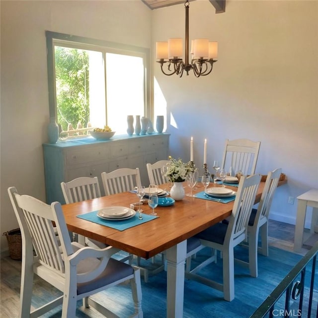 dining area featuring an inviting chandelier and hardwood / wood-style floors