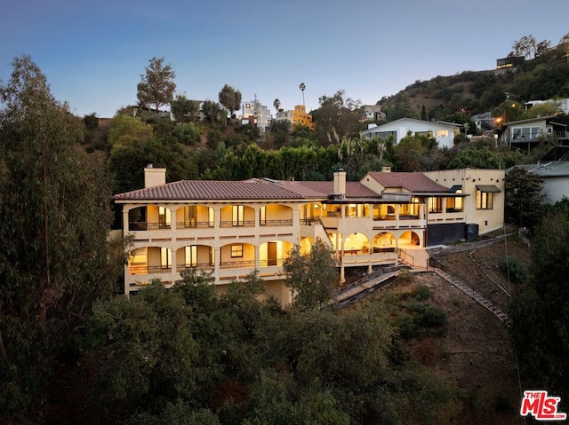 back of property with a balcony