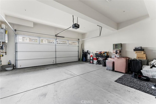 garage featuring a garage door opener and water heater