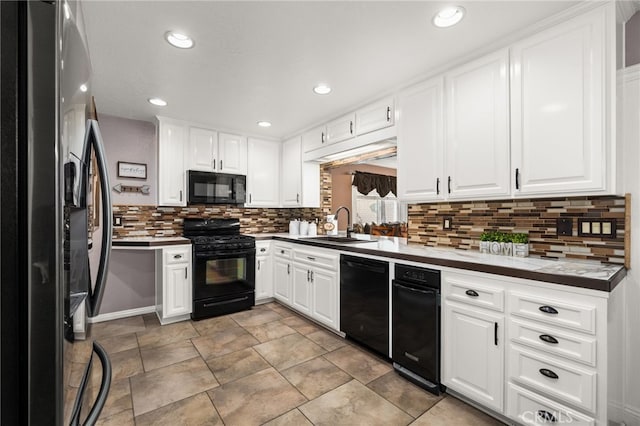 kitchen featuring tasteful backsplash, white cabinetry, sink, and black appliances