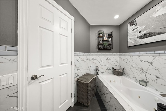 bathroom featuring tiled bath, tile patterned floors, and tile walls