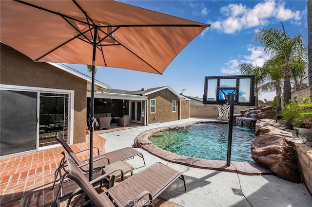 view of pool featuring pool water feature and a patio