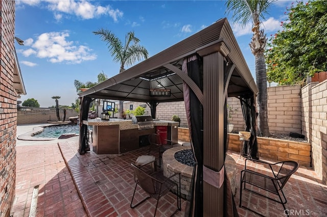 view of patio / terrace with a fenced in pool, an outdoor kitchen, exterior bar, a gazebo, and a grill