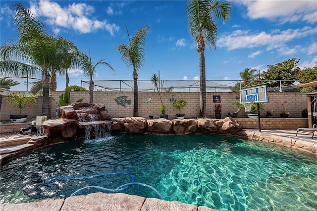 view of pool with pool water feature and basketball court