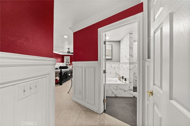 bathroom featuring tile patterned floors, ceiling fan, and a tub