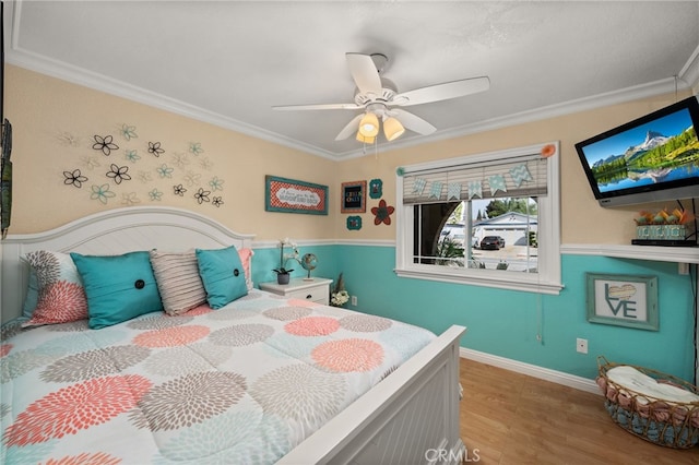 bedroom with ceiling fan, crown molding, and wood-type flooring