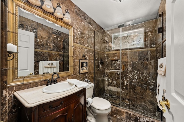 bathroom featuring vanity, a shower with door, and tile walls