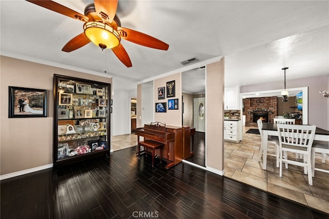 miscellaneous room featuring hardwood / wood-style floors, ceiling fan, crown molding, and a textured ceiling